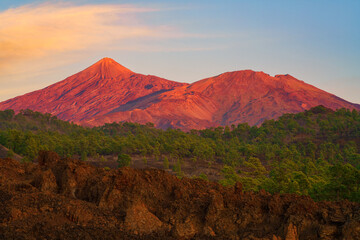 Amazing landscape with Teide volcano view (pico del Teide) and lava fields in red sunset light, the highest mount of Spain in Teide National park, Tenerife, Canary Islands, outdoor travel background