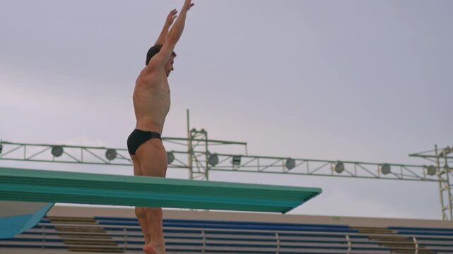 A professional athlete perfects his spring dive during training. The video showcases his dedication, technique, and athletic prowess as he practices each dive with precision and focus. Slowmotion