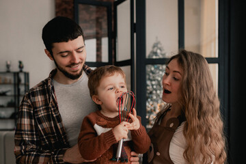 Happy moments in the family and time spent together with relatives on the eve of Christmas. Concept of gifts for New Year, Mother's Day and Father's Day. Modern kitchen interior. Part of a series