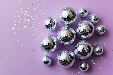 Small disco balls on purple background. AI generated