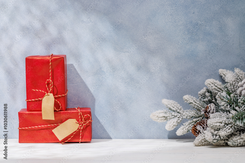Aufkleber christmas template featuring gift boxes and snowy fir tree branches on a table with shadows and sun 