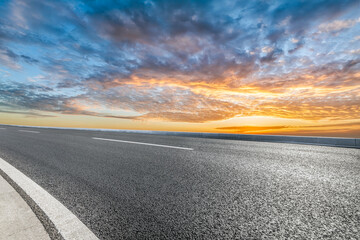 Empty asphalt road and sky cloudscape at sunset