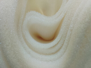 roll of thin white foam sponge. plain sheet of curved style texture material