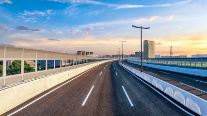 Viaduct road and cityscape in modern city at sunset