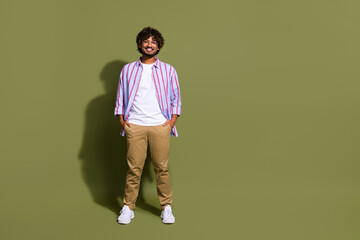Portrait photo of candid arab businessman in trendy casual shirt and eyeglass posing confident isolated on khaki color background