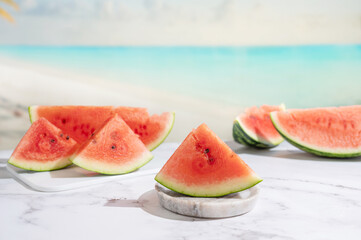 Pieces of ripe watermelon on a table on the sea beach.