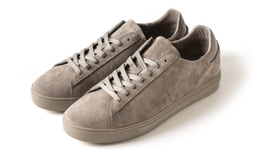 Pair of new male gray nubuck leather sneakers or sport shoes isolated on white background. Close up.