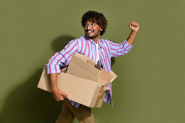 Photo of friendly guy with wavy hair dressed striped shirt in glasses hold rubbish look empty space...