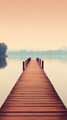 Fototapeta premium Wooden dock extending into a misty lake at sunrise.