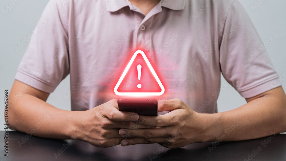Leinwandbilder mobile security alert, a man using a smartphone with a scam warning symbol to highlight the growing 
