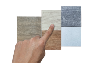 interior architect's hand chooses material samples contains oak and ash wooden, stone travertine, concrete textures isolated on background with clipping path. indoor tiles sample for finishing.