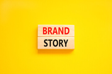 Brand story branding symbol. Concept words Brand story on beautiful wooden blocks. Beautiful yellow background. Business brand story branding concept. Copy space.