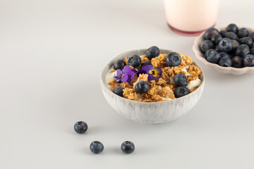 A healthy nutritious breakfast of natural Greek yoghurts, granola and fresh berries. Copy space
