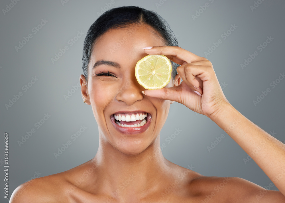 Poster Happy woman, portrait and lemon with vitamin C for skincare, beauty or natural cosmetics on a gray studio background. Young, female person or model with smile for organic citrus fruit or antioxidant