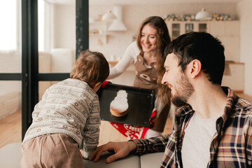 Happy moments in the family and time spent together with relatives on the eve of Christmas. Concept of gifts for New Year, Mother's Day and Father's Day. Modern kitchen interior. Part of a series