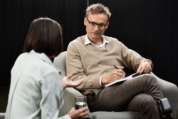 A journalist conducts an in-depth interview with a female specialist, capturing insights in a...