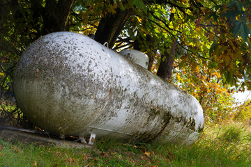 An image of a very old an rusted propane gas cylinder which is no longer in use. 