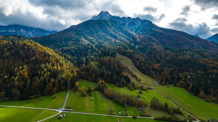 A stunning aerial view of Gozd Martuljek and its surroundings in autumn, captured by drone. The...