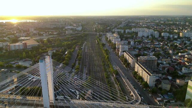 High angle drone footage of the central train station in Bucharest, Romania. Locomotives, rails and wagons seen from above on a summer sunny afternoon. Top down shot of colorful trainyard.
