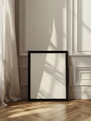 Black frame with empty canvas on light wall with sunlight in classic room.