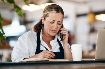 Mature woman, coffee shop or owner with phone call, notebook or laptop for order confirmation....