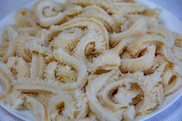 Beef tripe (bucho), beef stomach, tripe on a white plate. Dobradinha