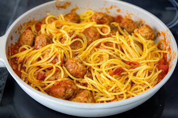 Traditional spaghetti with tomato sauce and meatballs and grated parmesan cheese