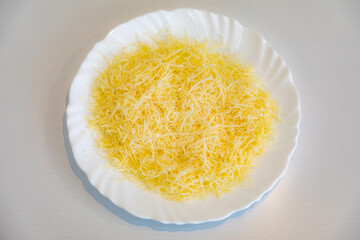 Grated parmesan cheese on a white plate. Pecorino Romano cheese
