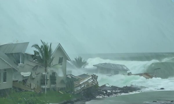 Massive destruction caused by Category 5 hurricane with powerful storm surge demolishing coastal homes and landscapes