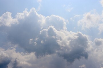 The big puffy white clouds in the blue sky.