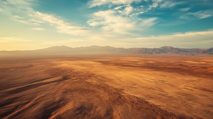Aerial view of the Atacama Desert with barren, sunlit plains and large open sky for copy