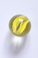 Close up of a glass marble on white background with copy space.