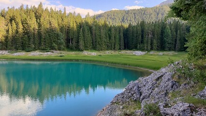 A large body of water that is completely surrounded by trees and rocks