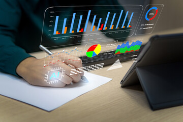 Close up businessman writing a paper in the office, side view, with hologram tech graphics, business concept
