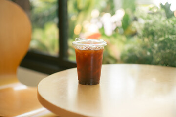 Dark coffee in  mug on wooden table..