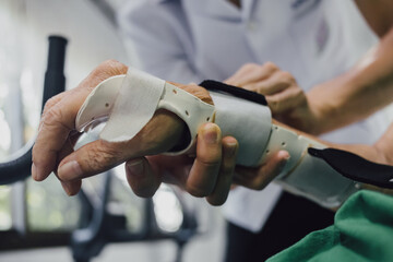 Therapist making asissistive device for immobilize patient wrist and hand pain from rheumatoid...