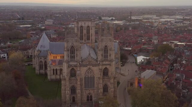 Drone shot of York Minster cathedral with surrounding cityscape at dusk in York, England.