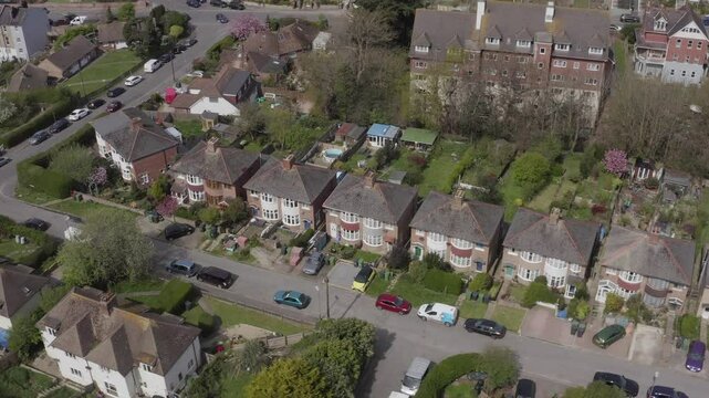 Drone footage shows a residential neighborhood in Hastings on a sunny day in England, UK