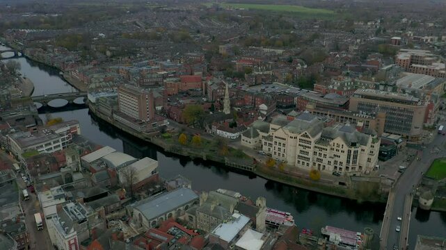 Drone shot capturing the city of York with the River Ouse flowing through it, showcasing urban architecture and waterways in England, UK.