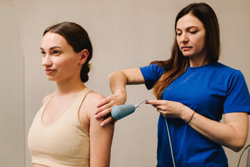 Diathermy. Using high frequency currents to reduce pain and assist recovering body tissues. Doctor...