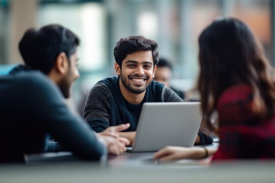 A group of international Indian students working laptop conversation college.