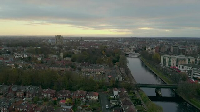 Drone shot of York's cityscape at dusk with the River Ouse and York Minster in view in York, UK