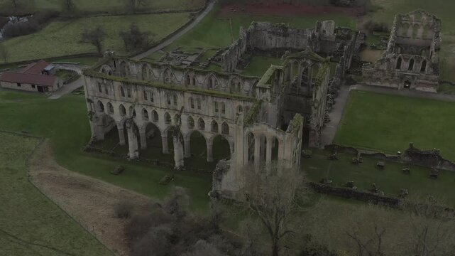 Drone shot of Rievaulx Abbey ruins in a serene landscape in North Yorkshire, England