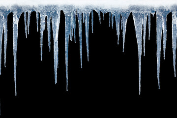 Long icicles on black isolated background.