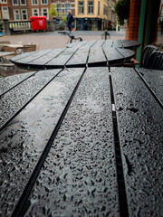 Black coffee shop table surface, covered with raindrops, Leiden, Netherlands