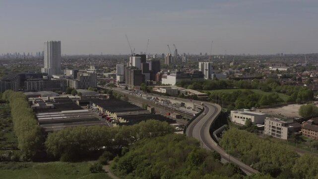 Rising aerial shot of Tottenham cityscape showing urban development, roads, and green areas in London, UK