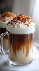 Close-up of a caramel macchiato topped with whipped cream and caramel drizzle, showcasing its rich texture and inviting presentation.