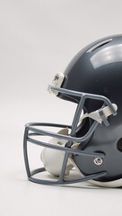 Fototapeta premium Sleek metallic football helmet on a clean white backdrop