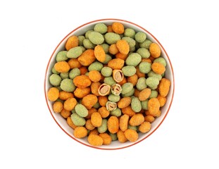 Mix of coated peanuts with wasabi and cayenne chili peppers in a bowl on white background. Spicy...