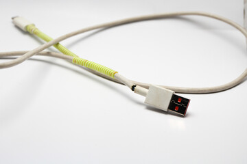 USB cable type C tangled over white isolated background